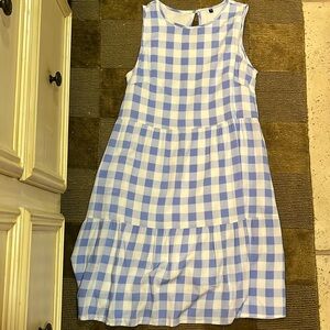 Adorable blue gingham tier dress with pockets.